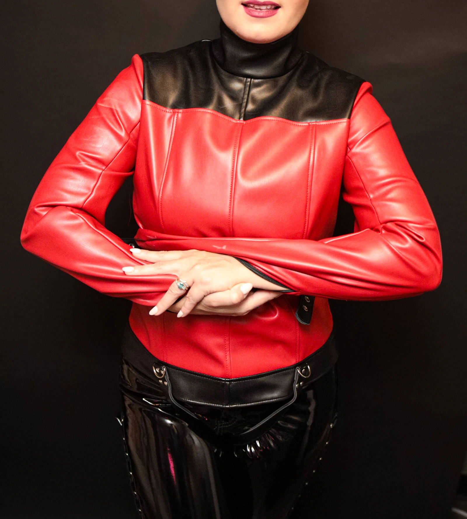 Experimentalist wearer with both hands exposed through the sleeve openings.