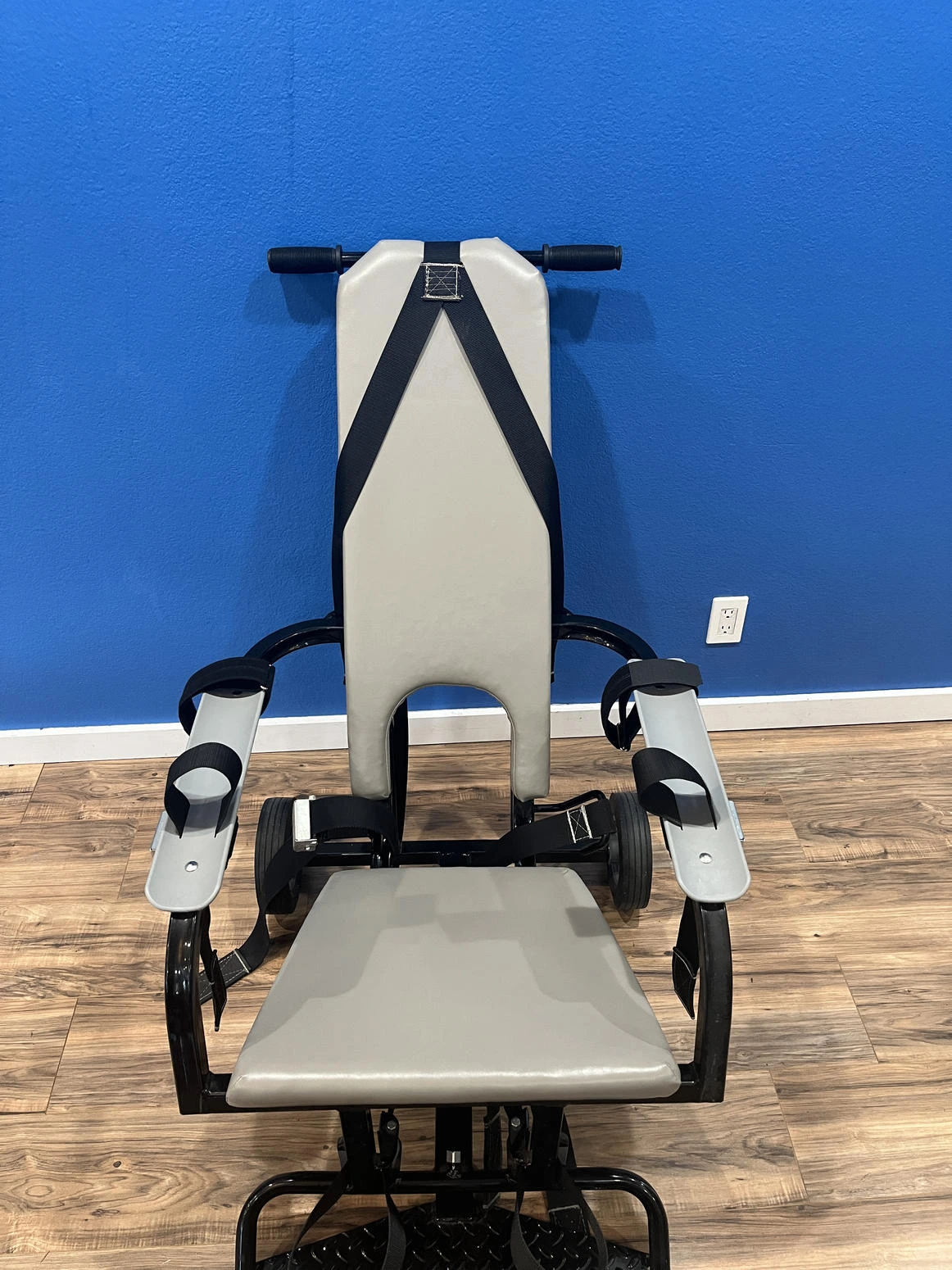 Restraint chair shown from the front indoors.